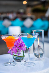 Two cocktails blue and orange at a beach bar in Hua Hin, Thailand
