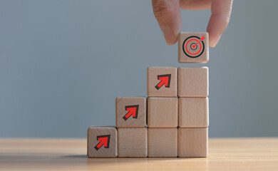 Target concept, objective, virtual target board and rising arrows screen printed on wooden cubes. set goals for business success