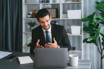 Professional businessman in black suit, present financial data or BI paper via laptop during online...