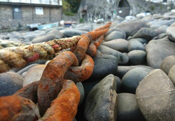 Closeup shot of a rustic boat chain on the stones