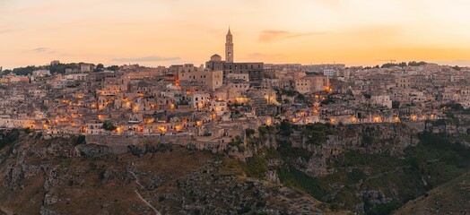 Obraz premium Aerial panoramic view of Sassi di Matera historical place against sunset sky in Matera, Italy