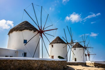Beautiful shot of the Windmills of Mykonos under the clouds in Greece - obrazy, fototapety, plakaty