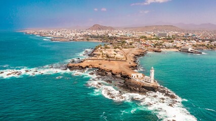 Aerial view of the shore of Praia de Santiago and the Praia lighthouse on a sunny day