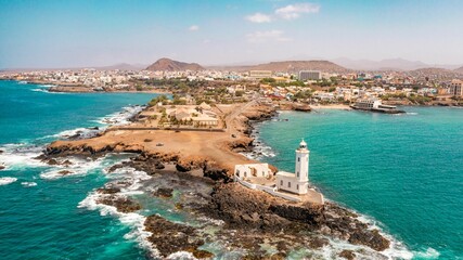 Aerial view of the shore of Praia de Santiago and the Praia lighthouse on a sunny day