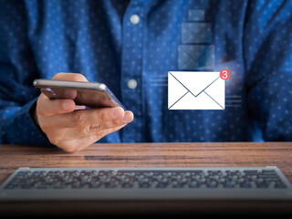 Business people use mobile phones to send or receive a new message in the office. Business communication, internet, and technology concept..