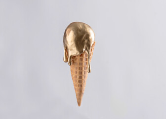 Gold metallic ice cream cone melting isolated on white background