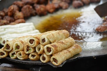 Fried rolls stuffed with meat in the street market