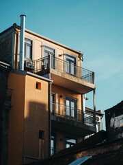 Couple of buildings with windows, a balcony, and balconies