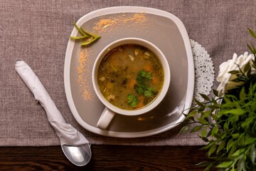 this is a photo of a bowl of soup with spoon on top