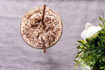 a hot chocolate smoothie with whipped cream, sprinkles and nuts on