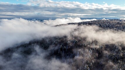 High-angle of clouds above a frozen forest in winter