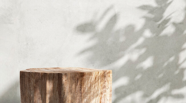 Natural log wood podium in dappled sunlight, tropical tree leaf shadow on minimal gray polished cement wall for modern, luxury organic beauty, fashion, cosmetic, skincare product display background 3D