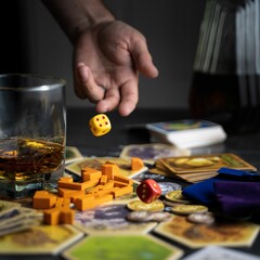 Closeup shot of a man playing a board game with dice