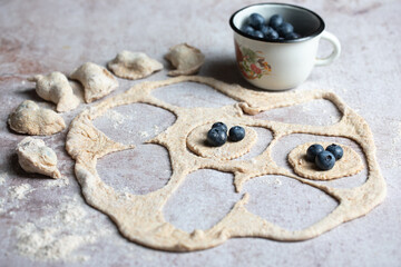 making pyrogies with blueberries. Making varenyky with blueberries. Ukrainian dish