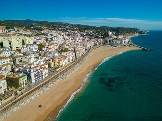 Aerial shot of buildings by the coast in Barcelona, Spain on a sunny day