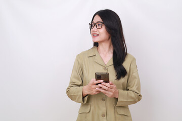 Attractive young indonesian civil servant woman holding cell phone while looking sideways