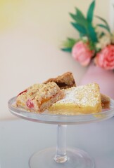 Vertical shot of a small square-shaped cake arranged in a plate on a kitchen counter