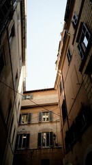 Fototapeta na wymiar Low-angle shot of old city buildings against the blue sky