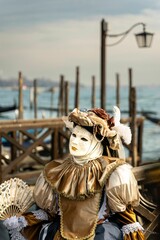 Fototapeta na wymiar Person wearing a traditional costume, celebrating the Carnival of Venice