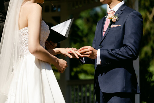 Groom Placing Ring on Bride's Finger