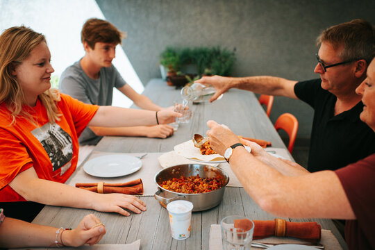 Family dinner outdoors in summer
