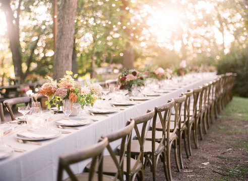 horizontal evening dinner reception tablescape outside