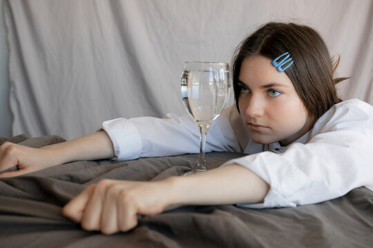 Woman Looking At Glass of Water