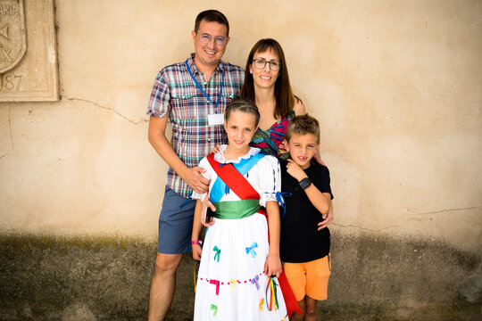 Happy family with their daughter in traditional costume