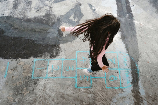 girl playing hopscotch