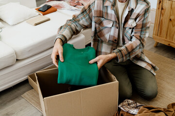  man folding clothes at home