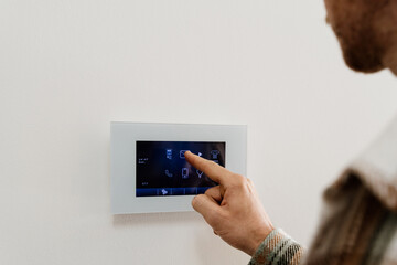 man using smart panel device at home