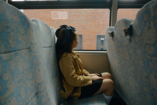 A schoolgirl sits on the bus