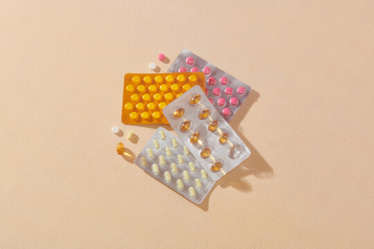 Capsule pills in blister on a beige background