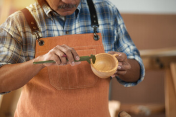 Senior carpenter checking finished work, woodworking shop business owner