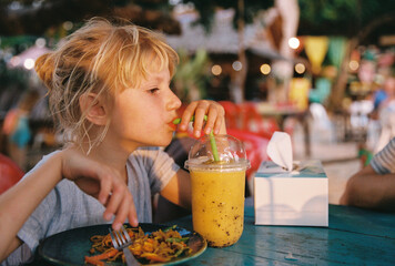 A girl with a smoothie in a beach cafe