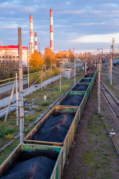 wagons loaded with coal on sunset railroad tracks landscape  