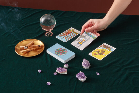 Fortune teller laying out tarot cards. - Powered by Adobe