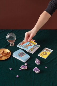 Female medium laying out tarot cards.