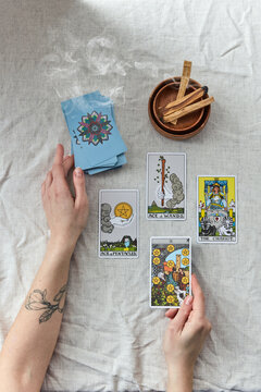 Tarot reader laying out cards spread.