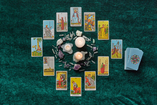 Tarot and magic crystals in a circle around candles.