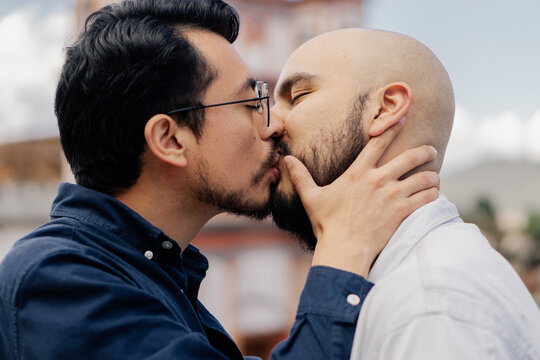 Portrait of a gay couple kissing.