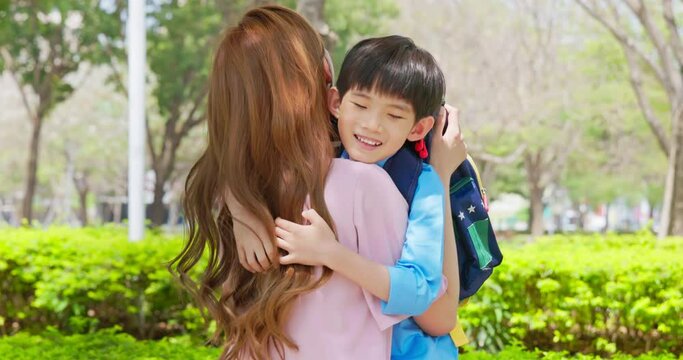 asian mother hugs her schoolchild