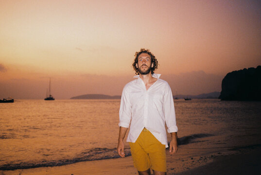 Man walking on idyllic tropical  Railey beach during vacation. 