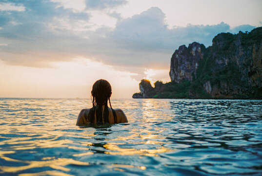 Woman swimming at sunset in Andaman sea 