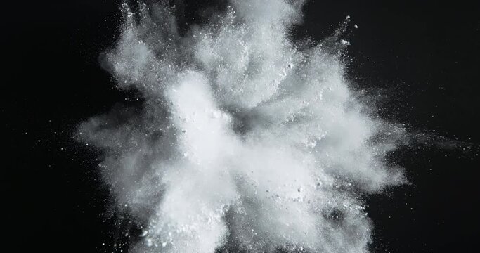 Slow motion of Top view of explosion of white powder dust spreading around