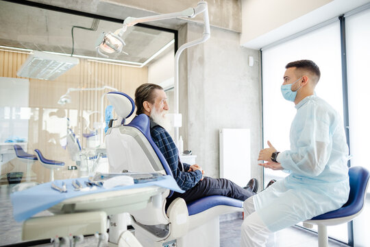 Dentist workroom. Senior client. Special clothing. Communicate
