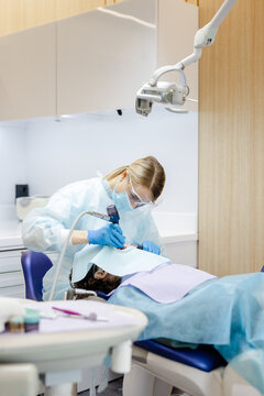 Anonymous. Skilled specialist. Clinic interior. Protective clothing