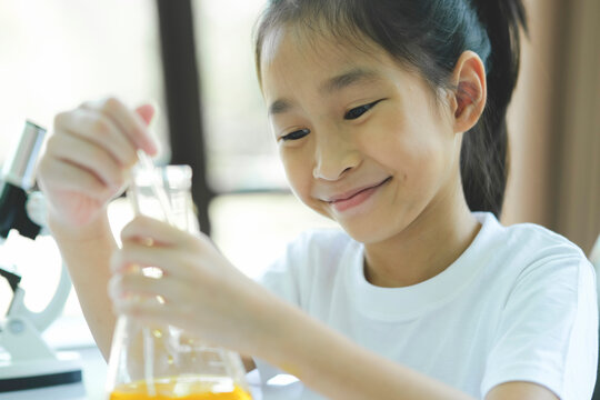Little child with learning science class in school laboratory