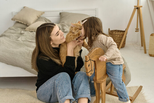 A little child kissing her cat 