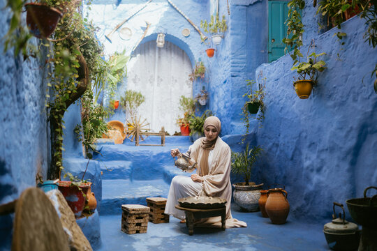 Muslim woman serving tea